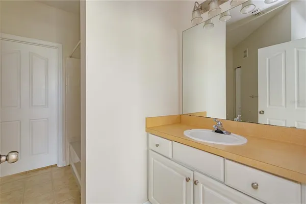 a bathroom with a sink and a white cabinet