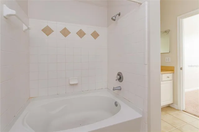 a white bath tub sitting next to a shower