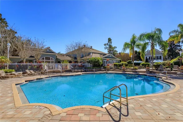 a view of a swimming pool and lounge chairs