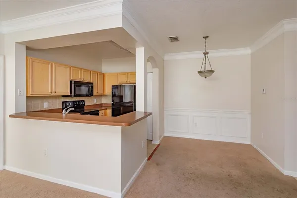 a kitchen with stainless steel appliances a refrigerator and a stove top oven