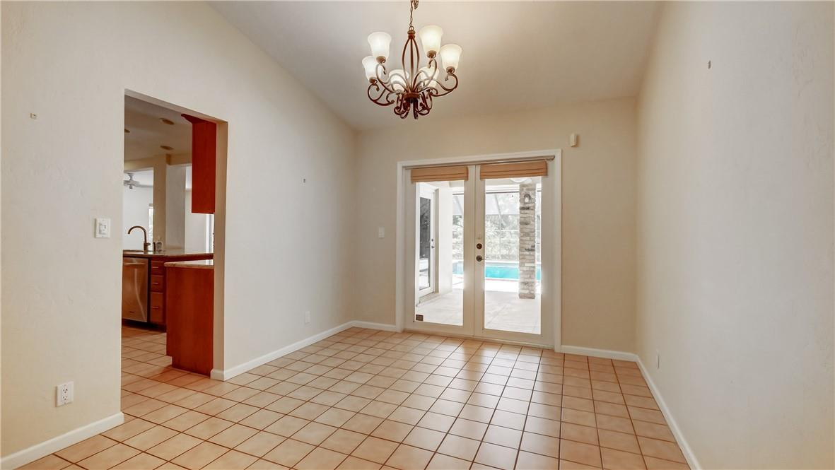 10890 Southwest 83rd Avenue Miami, FL 33156 - Photo 19 of 46 a view of a hallway with wooden floor and chandelier