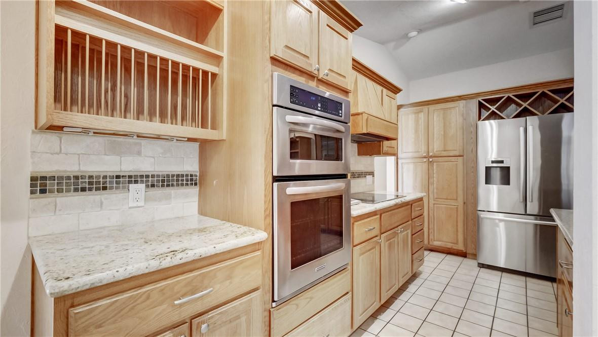 10890 Southwest 83rd Avenue Miami, FL 33156 - Photo 31 of 46 a kitchen with stainless steel appliances granite countertop a refrigerator and a stove top oven