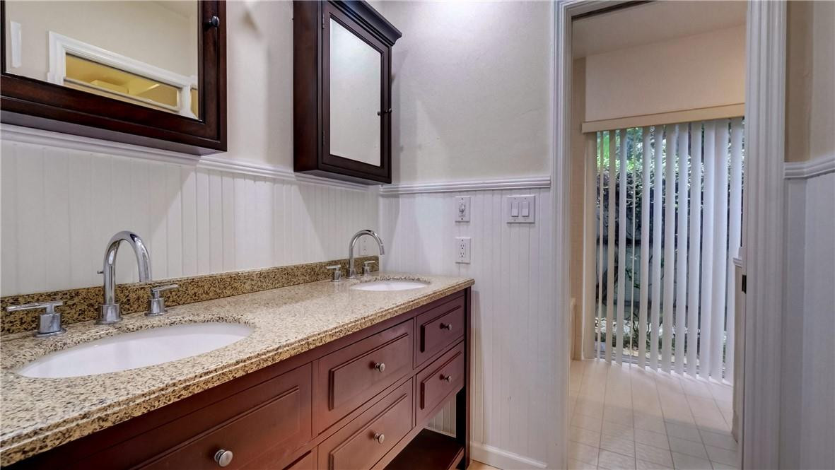 10890 Southwest 83rd Avenue Miami, FL 33156 - Photo 41 of 46 a bathroom with a granite countertop sink and a mirror
