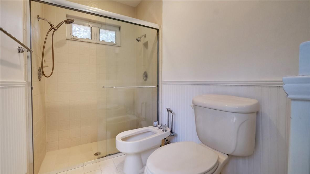 10890 Southwest 83rd Avenue Miami, FL 33156 - Photo 44 of 46 a white toilet sitting next to a bathroom sink and a shower