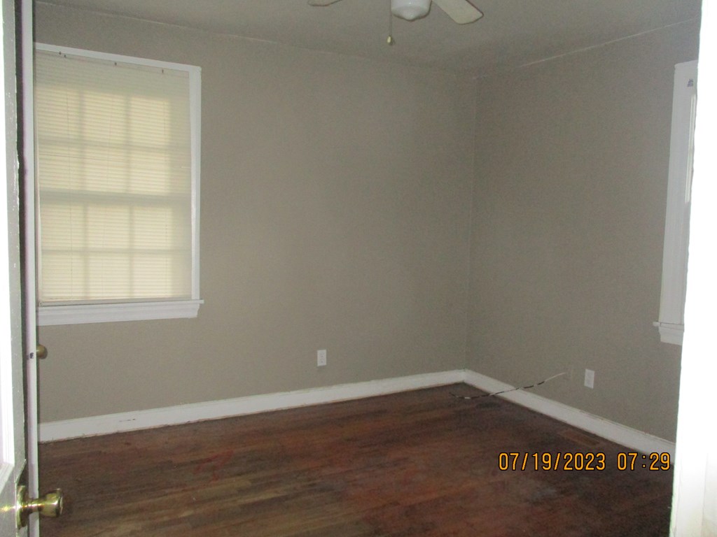 1036 Calvin Avenue Columbus, GA 31903 - Photo 12 of 23 an empty room with wooden floor and windows