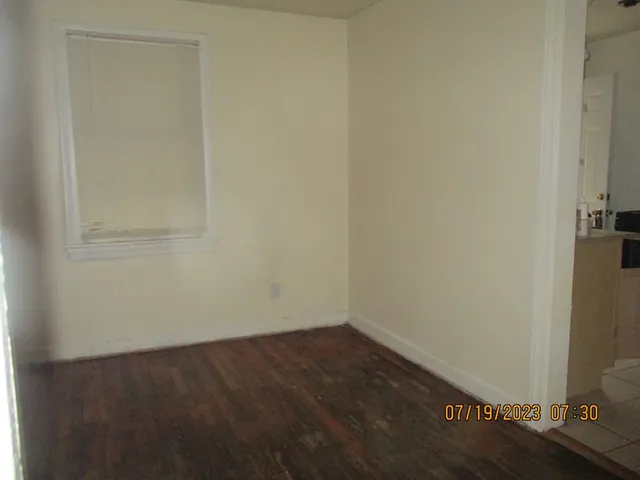 a view of a room with white walls and a window