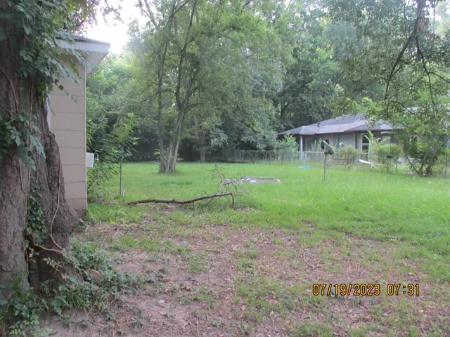 a view of a small house with a tree