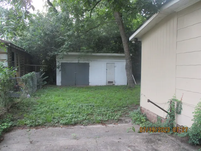 a kitchen with granite countertop a sink stove and cabinets