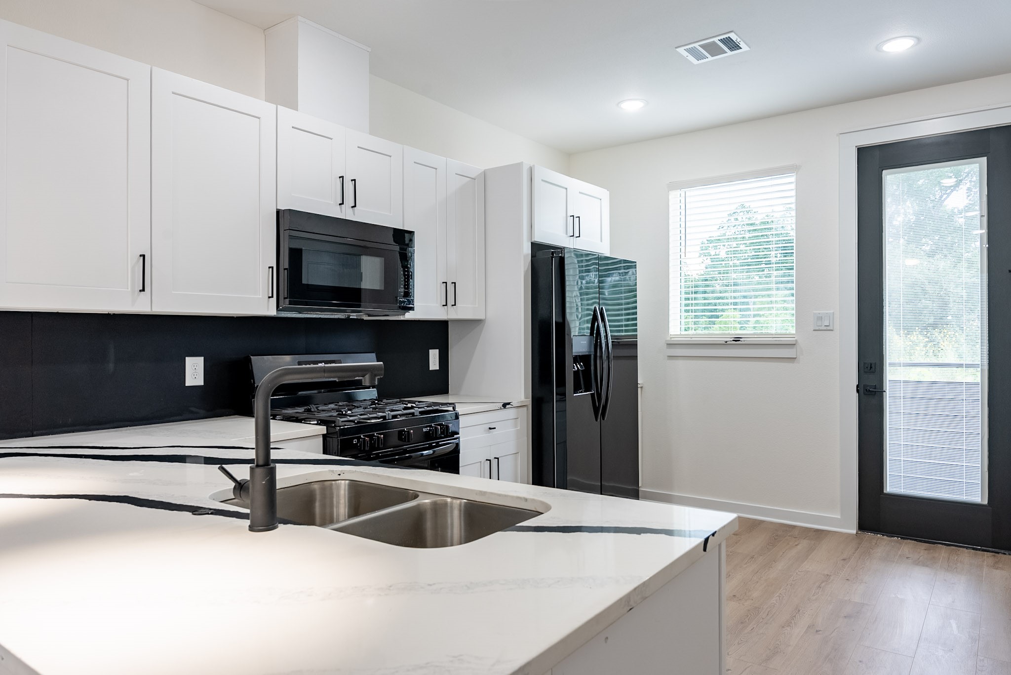 3522 Mansfield Street Houston, TX 77091 - Photo 5 of 12 Sleek contemporary kitchen w/ plentiful cabinet space.
