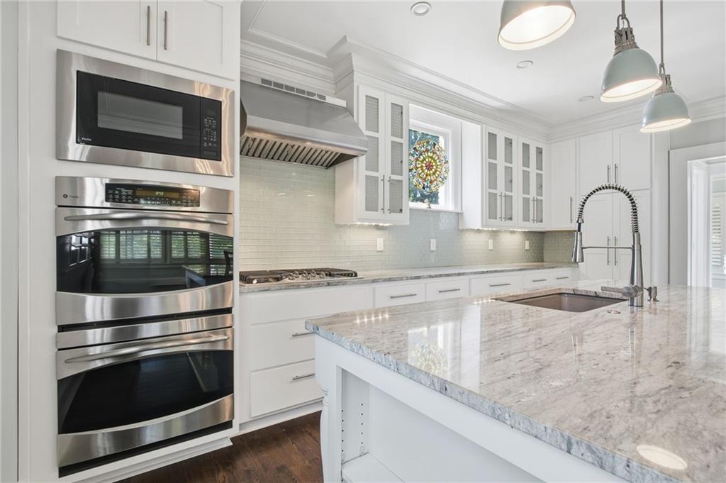 1417 Briarcliff Road Northeast Atlanta, GA 30306 - Photo 13 of 51 a kitchen with granite countertop a stove and a microwave