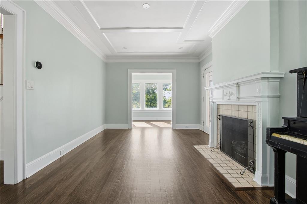 1417 Briarcliff Road Northeast Atlanta, GA 30306 - Photo 22 of 51 a view of an empty room with wooden floor fireplace and a window