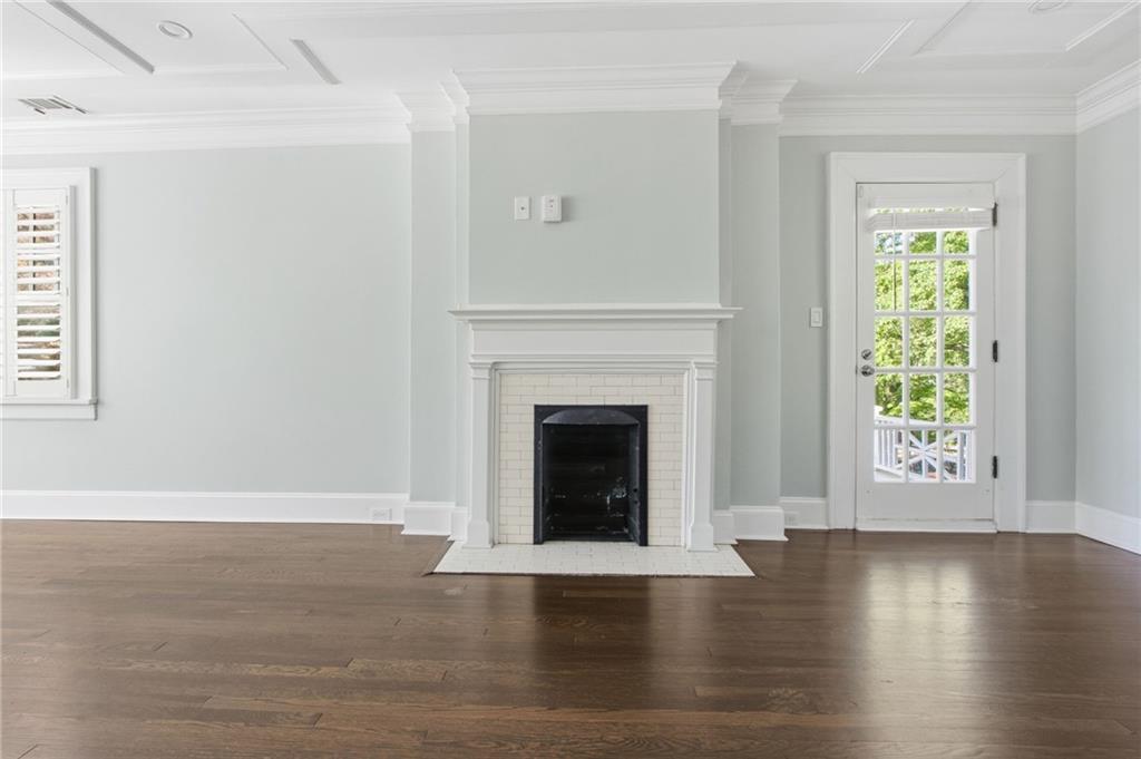 1417 Briarcliff Road Northeast Atlanta, GA 30306 - Photo 29 of 51 a view of a livingroom with wooden floor a fireplace and windows
