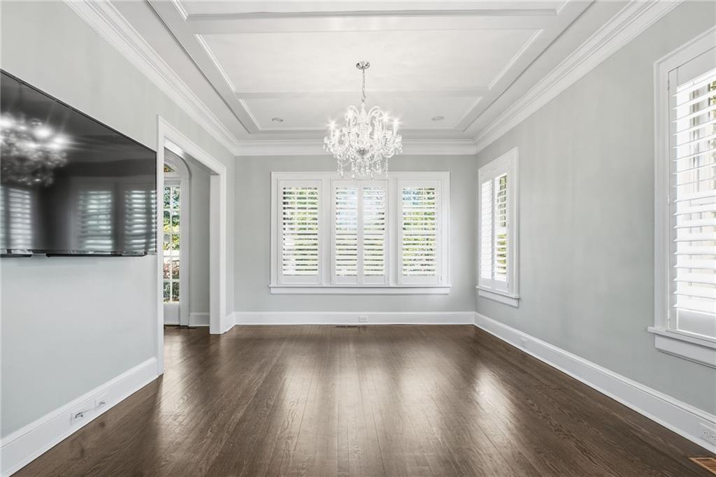 1417 Briarcliff Road Northeast Atlanta, GA 30306 - Photo 7 of 51 a view of an empty room with wooden floor and a window