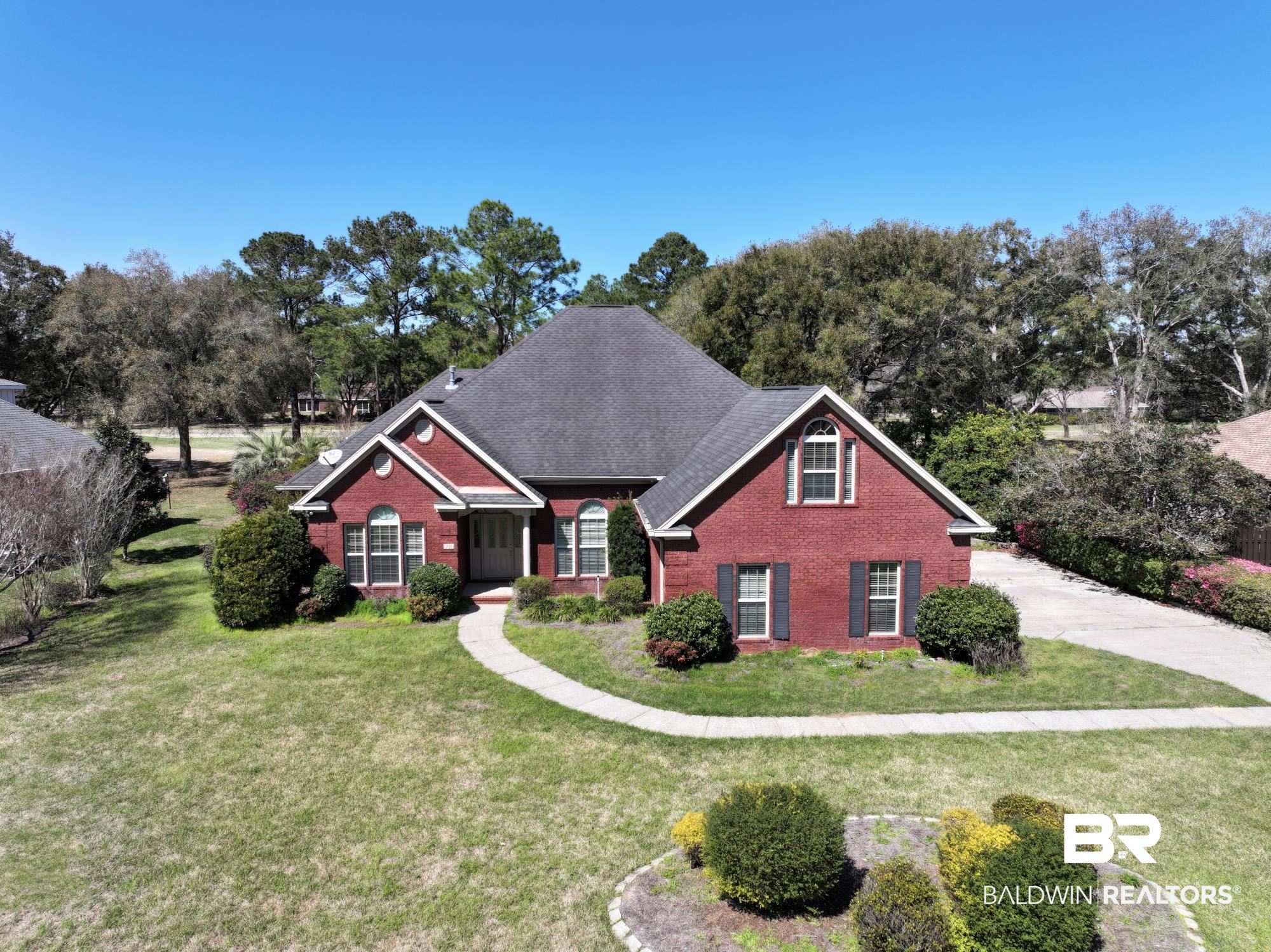 306 South Tee Drive Fairhope, AL 36532 - Photo 4 of 37 View of front of property with brick siding, roof with shingles, and a front yard