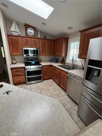 a kitchen with stainless steel appliances granite countertop a stove top oven a sink and dishwasher