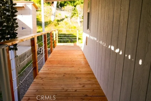 a view of a balcony with wooden floor