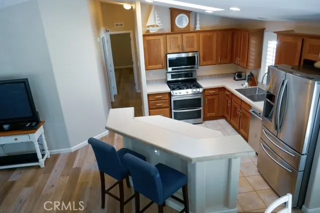 a kitchen with a refrigerator a stove top oven a sink and dishwasher
