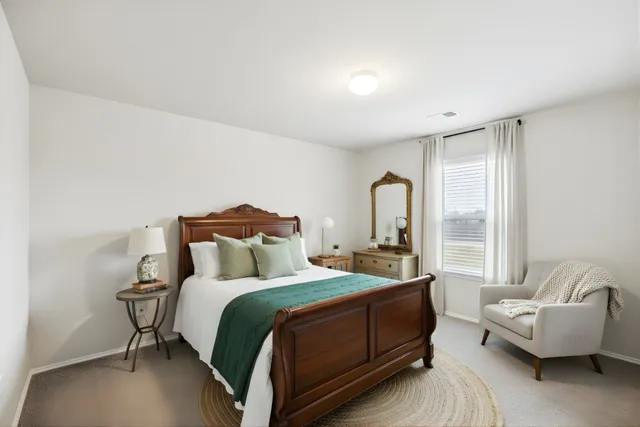 a bedroom with a bed couch and window