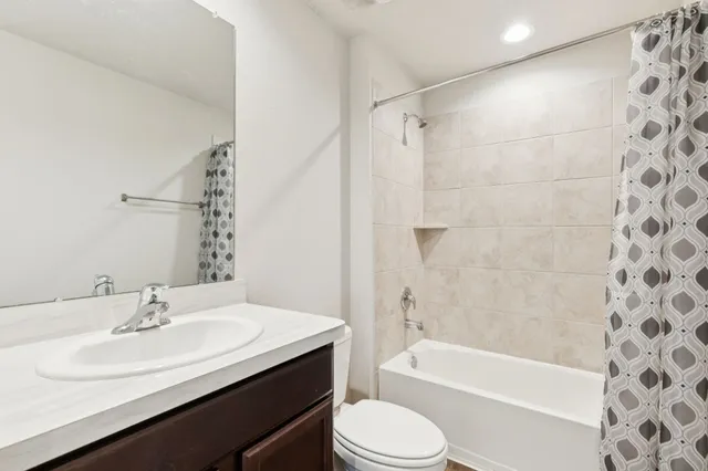 a bathroom with a sink a toilet and a bathtub