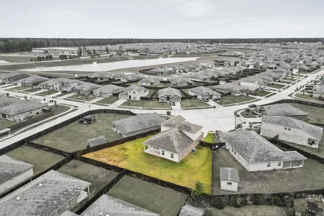 an aerial view of residential houses with outdoor space