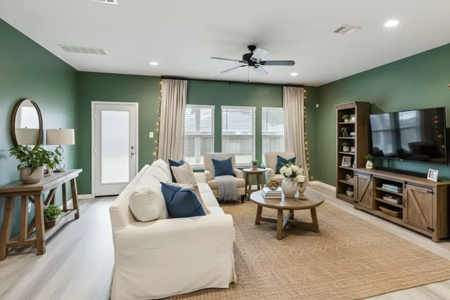 a living room with furniture and a flat screen tv