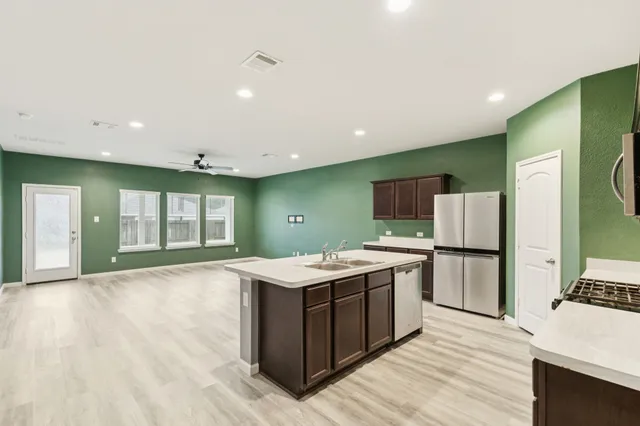 a kitchen with a sink and refrigerator