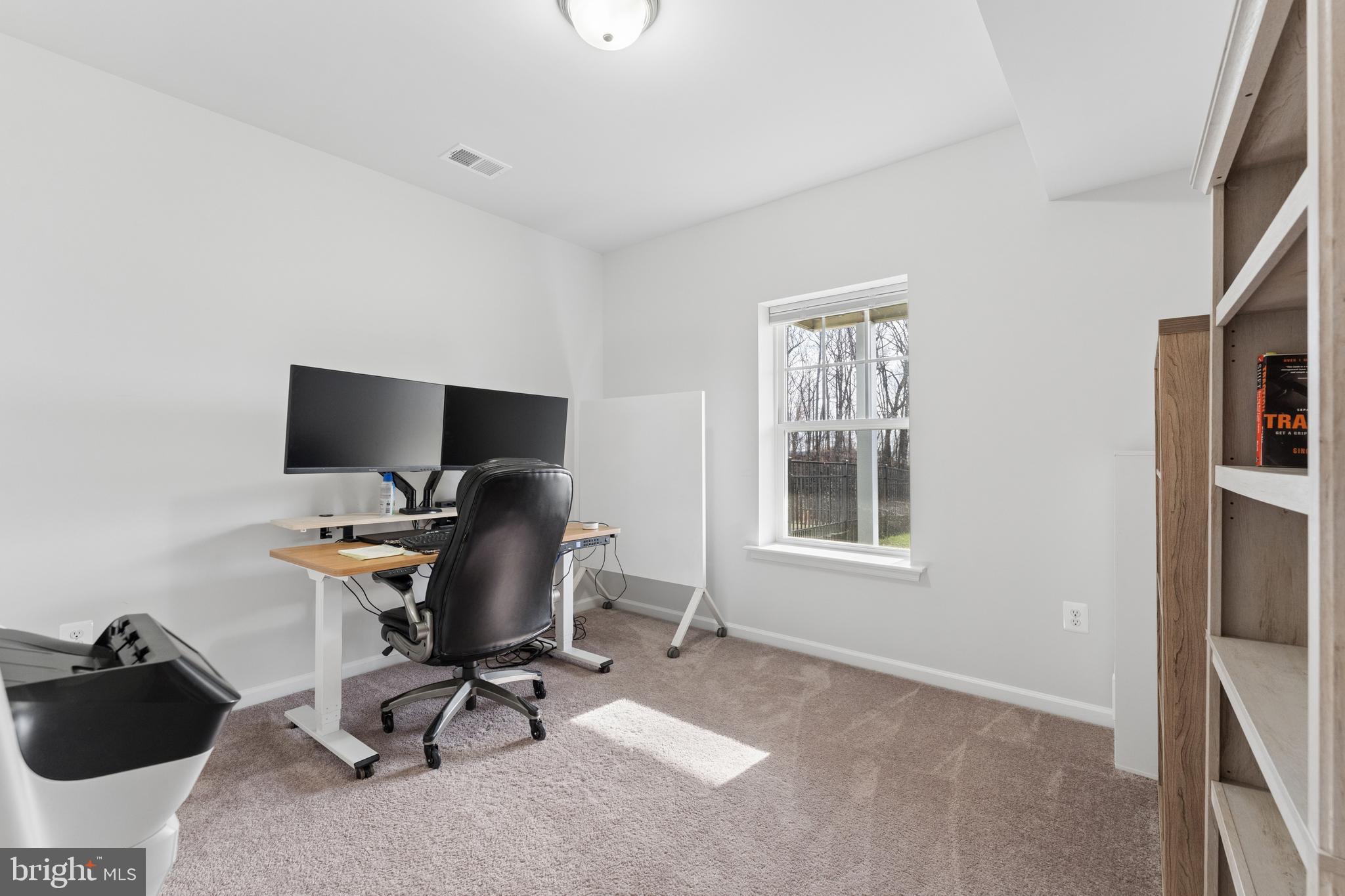 18320 Moss Garden Road Dumfries, VA 22026 - Photo 34 of 50 a view of a workspace with furniture and a window