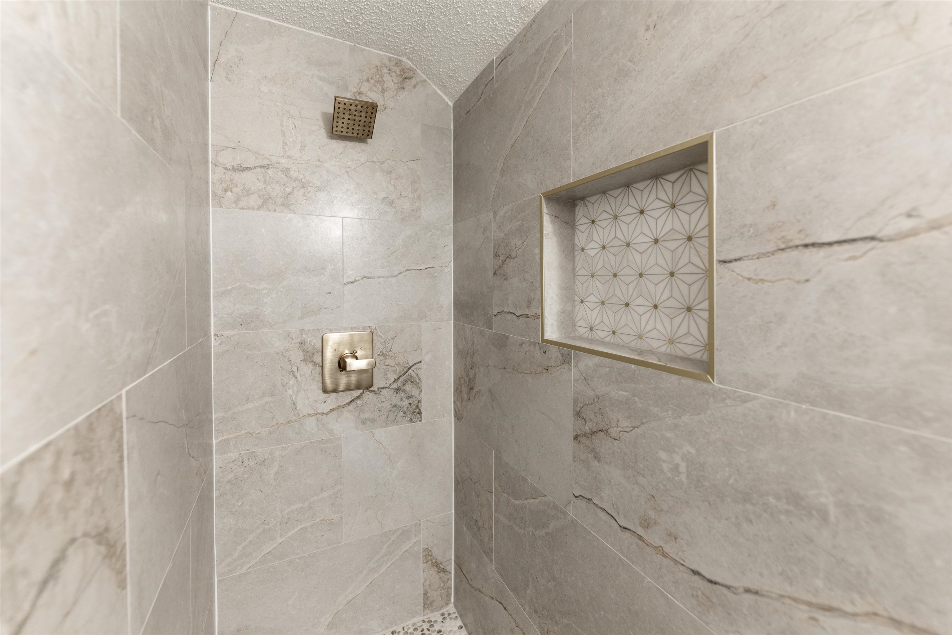 7421 Richmond Road Memphis, TN 38125 - Photo 36 of 39 Shower stall featuring large format grey tile with natural veining