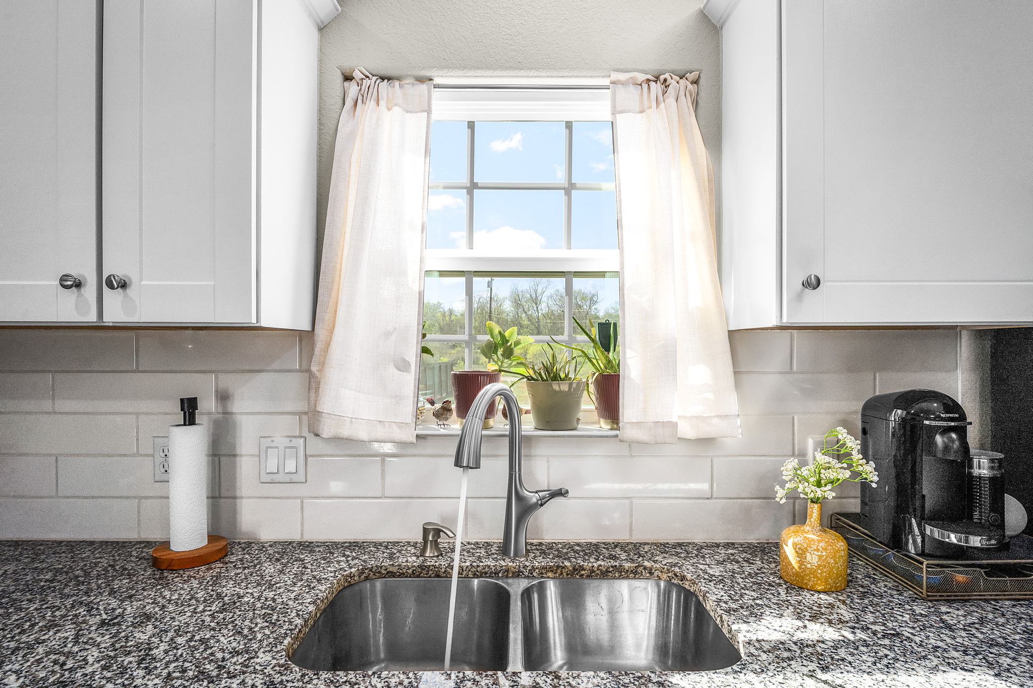 224 Spruce Avenue Luling, TX 78648 - Photo 14 of 31 a kitchen with granite countertop a sink and a window