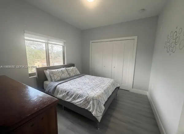 a bedroom with bed and a chandelier
