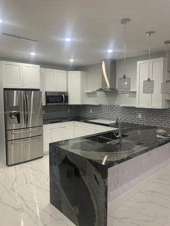 a kitchen with a sink stove and refrigerator