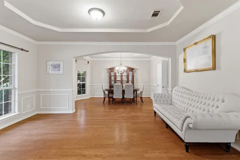 a living room with furniture and a chandelier