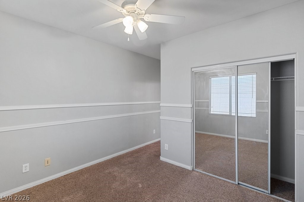 10336 Hawk Ravine Street Las Vegas, NV 89178 - Photo 37 of 59 This spacious bedroom offers comfortable carpeting and convenient mirrored closet doors.