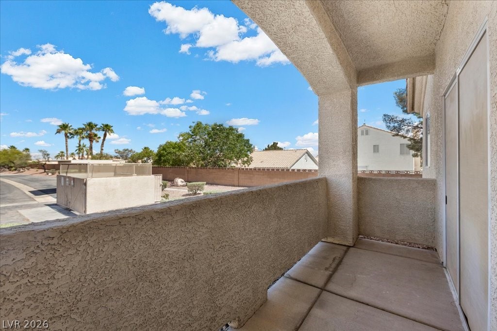 1881 West Alexander Road, Unit 1037 North Las Vegas, NV 89032 - Photo 24 of 31 A private covered patio with stucco walls offers a pleasant view of the surrounding landscape and sky.