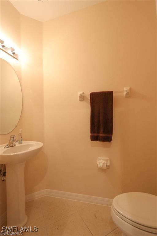 20056 Larino Loop Estero, FL 33928 - Photo 13 of 31 a bathroom with a sink a toilet and mirror
