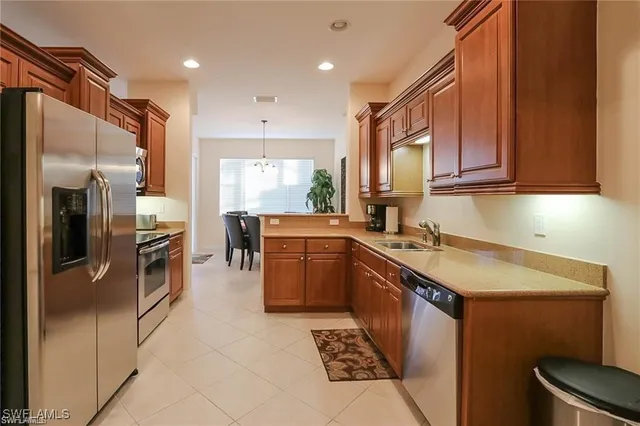 a kitchen with a sink appliances and cabinets
