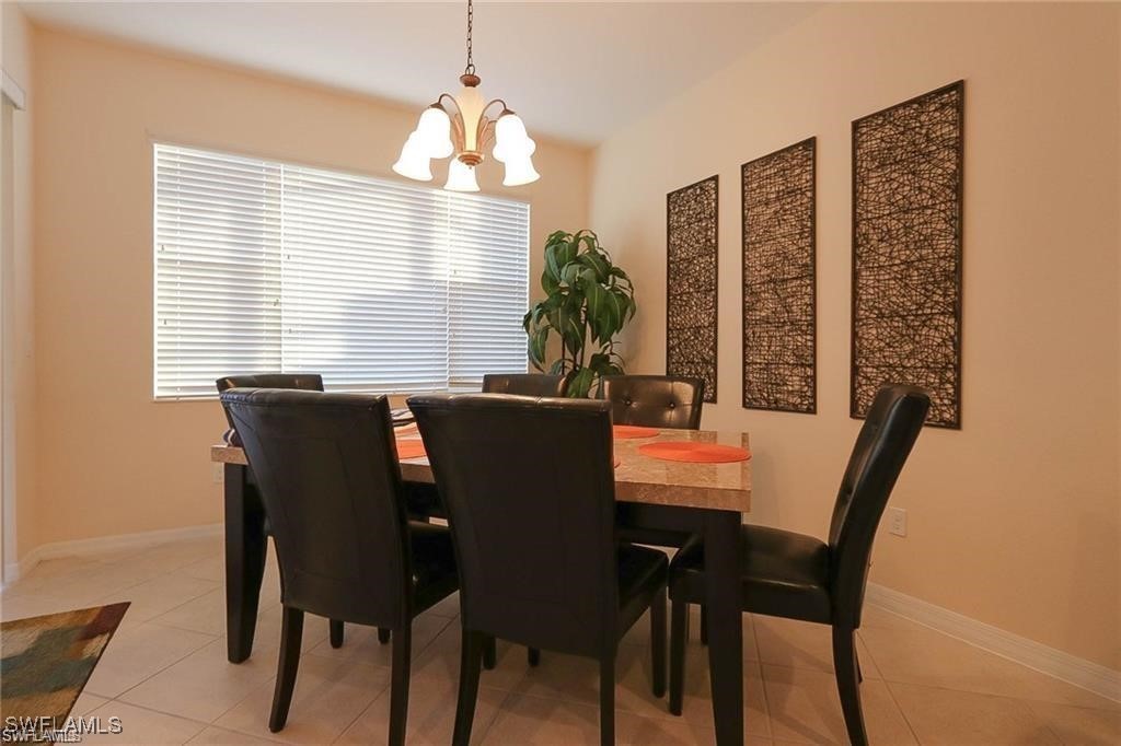 20056 Larino Loop Estero, FL 33928 - Photo 15 of 31 a view of a dining room with furniture and window