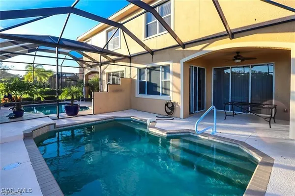 a house view with a swimming pool in front of it