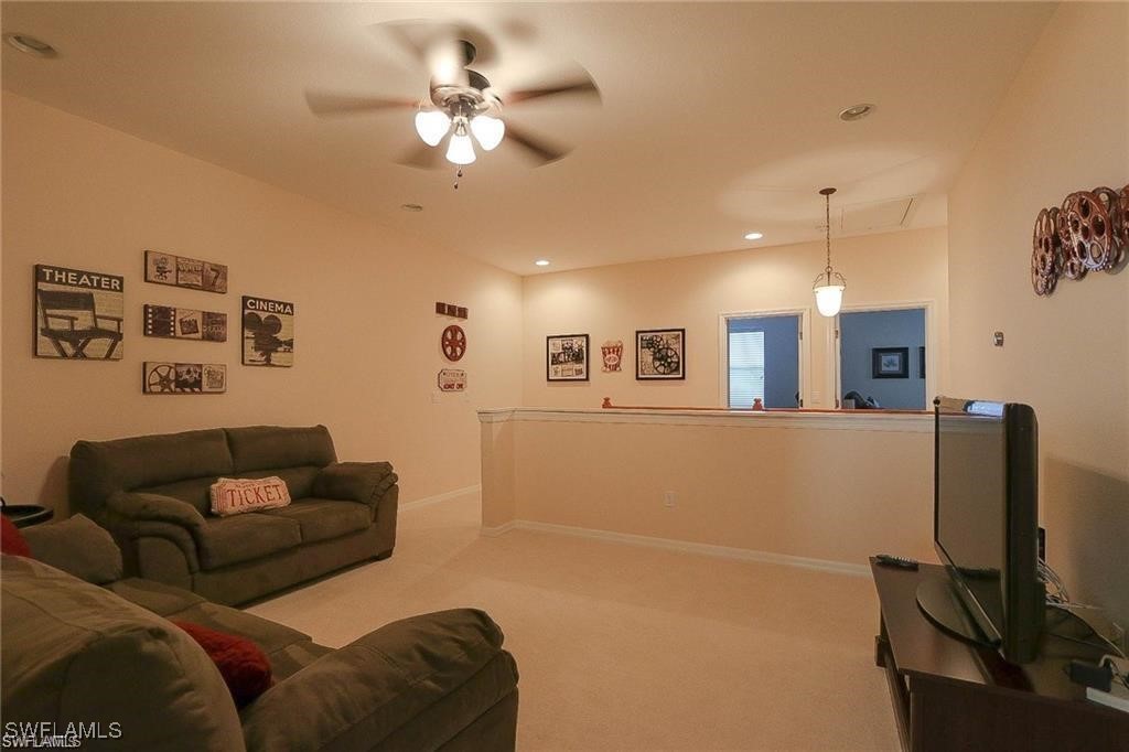 20056 Larino Loop Estero, FL 33928 - Photo 23 of 31 a living room with furniture and a flat screen tv