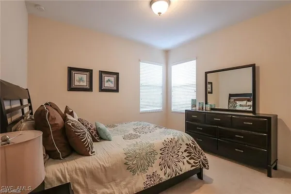 a bedroom with a bed and a dresser
