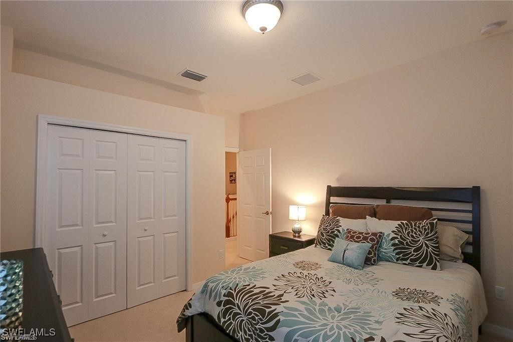 20056 Larino Loop Estero, FL 33928 - Photo 30 of 31 a bedroom with a bed and a lamp