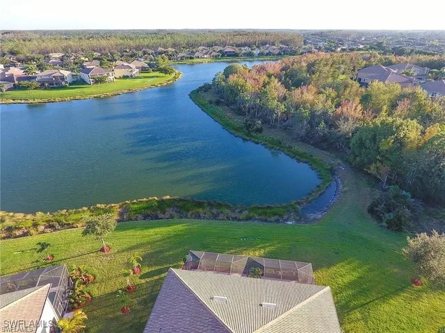 an aerial view of a house with a lake view