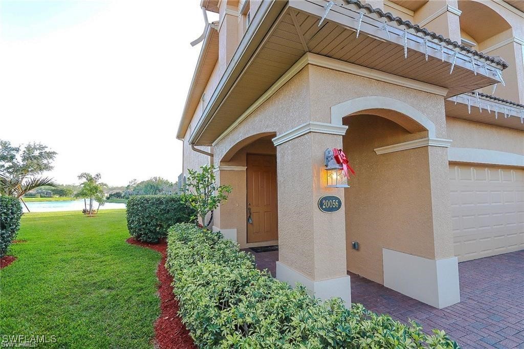 20056 Larino Loop Estero, FL 33928 - Photo 7 of 31 a front view of a house with garden