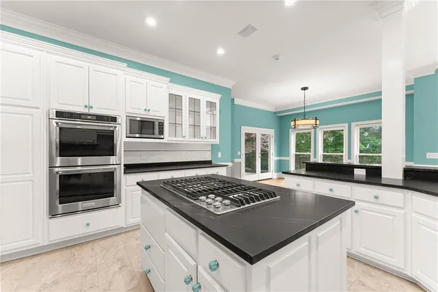an empty room with wooden floor chandelier fan and windows