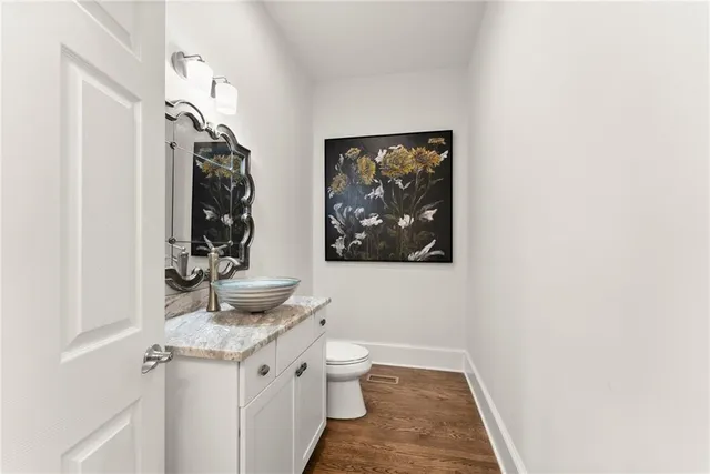 a view of a street with a yard and large trees