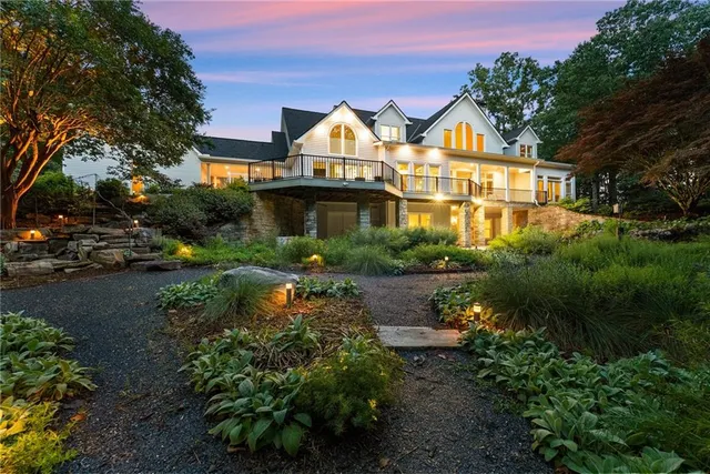 a front view of a house with a yard and trees