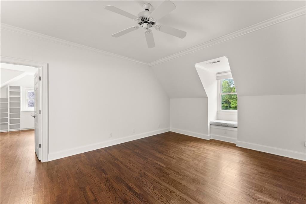 77 Old River Road Dahlonega, GA 30533 - Photo 56 of 98 an empty room with wooden floor chandelier fan and windows
