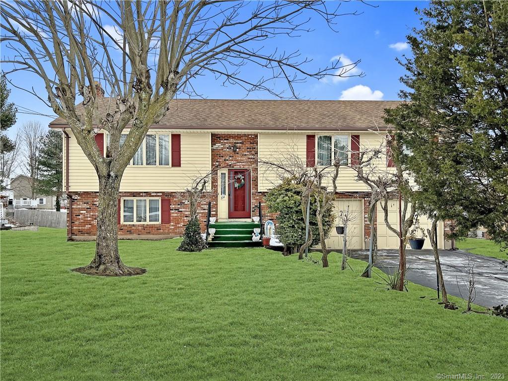a front view of house with a garden