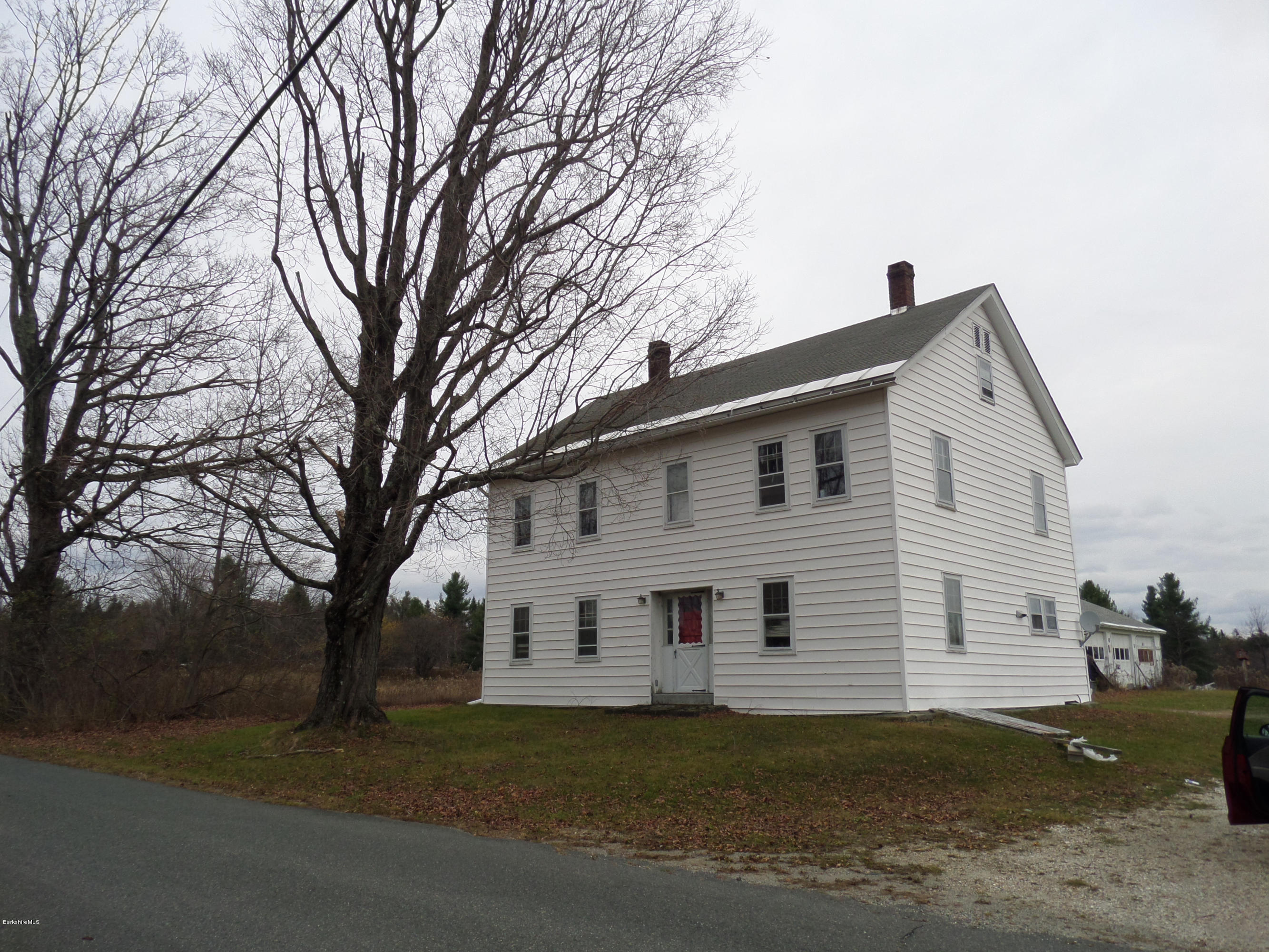 547 Loop Road Savoy, MA 01256 - Photo 1 of 13 a view of a white house next to a yard with a large tree