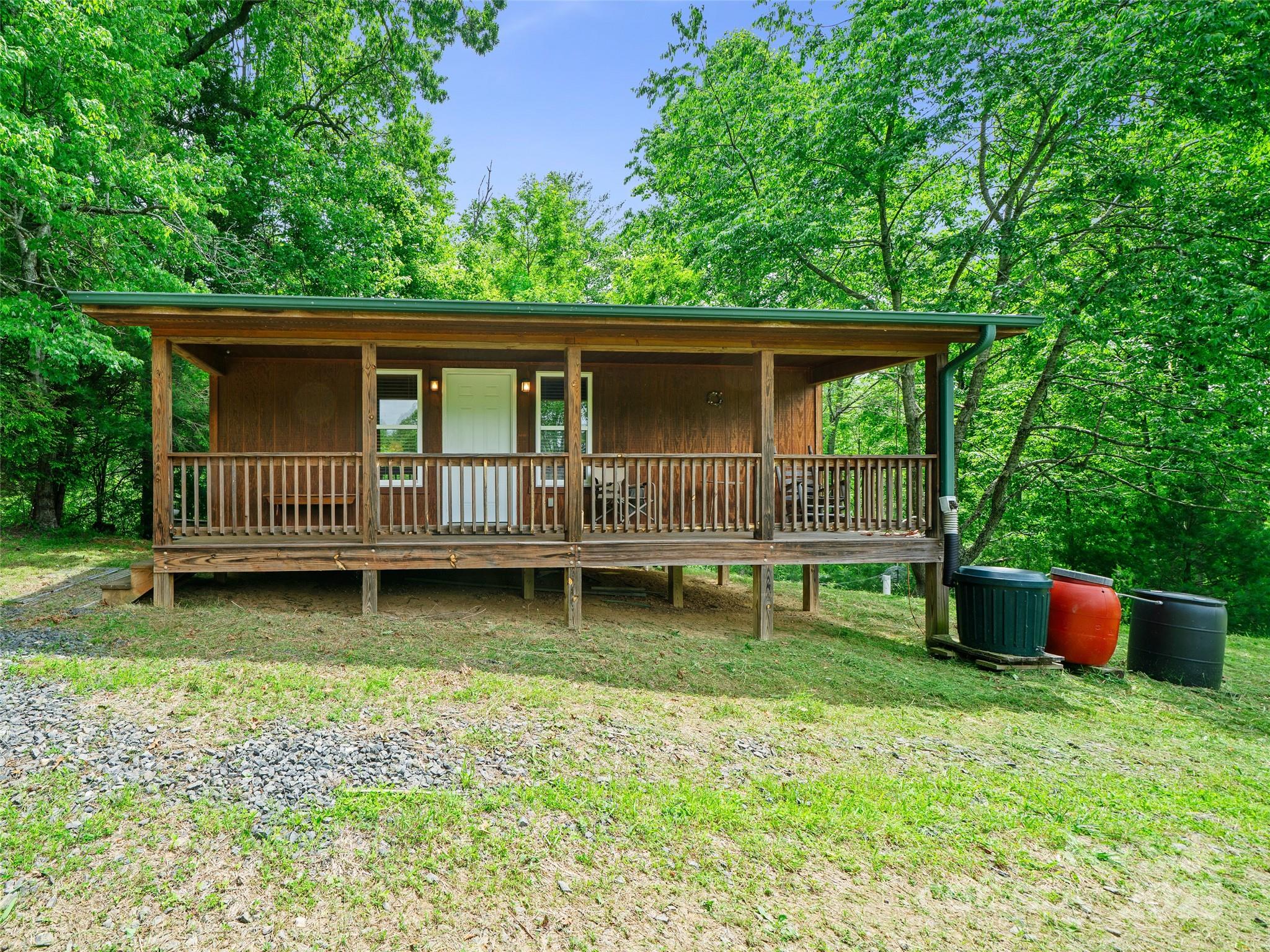 289 Bailey Settlement Road Green Mountain, NC 28740 - Photo 1 of 21 a backyard of a house with yard and trampoline